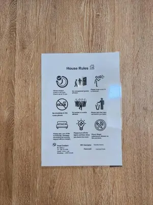 a piece of paper on a door with icons on it at 207-Olan Place Homely room Free Wi-Fi and Near BTS line in Bangkok