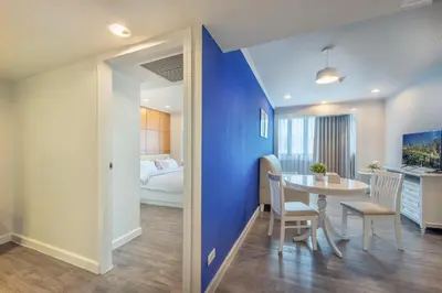 a room with a dining table and a bedroom at Neom Town Residence in Bangkok