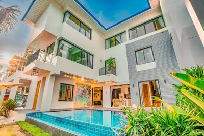 a house with a swimming pool in front of it at 944summer villa曼谷中心Asok&Tong Lor800海天别墅 in Bangkok