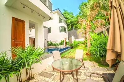 a patio with a glass table and chairs and a pool at 944summer villa曼谷中心Asok&Tong Lor800海天别墅 in Bangkok