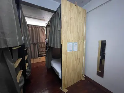 a small room with a door to a bunk bed at Happy Hope in Bangkok