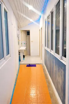 a hallway of a hospital room with a orange floor at White House Hostel Khaosan in Bangkok