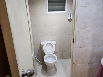 a bathroom with a white toilet in a stall at White House Hostel Khaosan in Bangkok