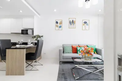 a living room with a couch and a table at Shine Sukhumvit 43 Apathotel Phrompong in Bangkok