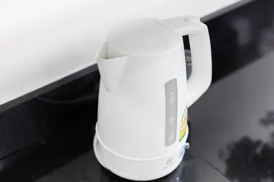 a white coffee pot sitting on a counter at Shine Sukhumvit 43 Apathotel Phrompong in Bangkok