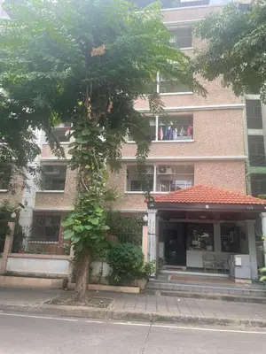 a tree is growing in front of a building at Viriyapon first floor2 in Bangkok