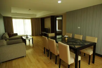 a living room with a table and chairs and a couch at The Ninth Place Serviced Residence in Bangna