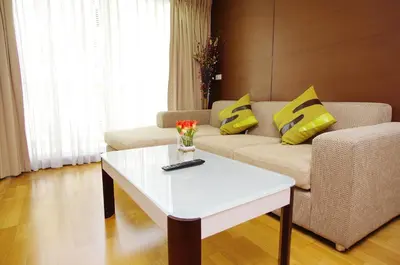 a living room with a couch and a white coffee table at The Ninth Place Serviced Residence in Bangna