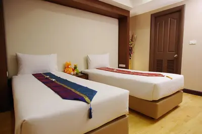 two beds sitting next to each other in a room at The Ninth Place Serviced Residence in Bangna