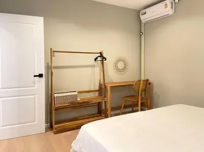 a bedroom with a bed and a mirror and a chair at Vélin Khaosan - 4th Floor apartment with 2Bedrooms in Bangkok