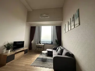 a living room with a couch and a tv at S87-7052 BTS Onnut High Floor Gym Swim Good View in Bangkok