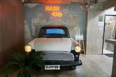 an old car is parked in a garage at Hash Apartment Silom Soi 3 - hip and funky with rooftop view in Bangkok