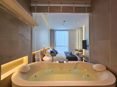 a bathroom with a tub in the middle of a room at The Address 28 in Bangkok