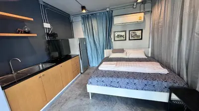 a small bedroom with a bed and a sink at Bangkok Chat box Hostel in Bangkok