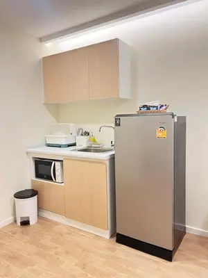 a kitchen with a refrigerator and a microwave at The Forest Building A-more than3nights stay-self checkin checkout in Bangkok