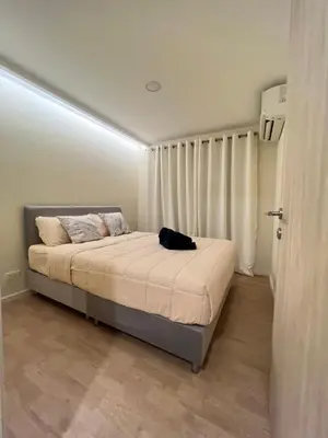 a bedroom with a bed with a black bag on it at The Forest Building A-more than3nights stay-self checkin checkout in Bangkok