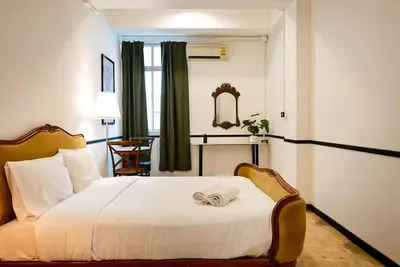a hotel room with a bed with a towel on it at The Character China Town เดอะ คาแรคเตอร์ เยาวราช Mrt วัดมังกร Pro in Khlong San