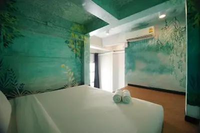 a bedroom with a bed with two shoes on it at The Character China Town เดอะ คาแรคเตอร์ เยาวราช Mrt วัดมังกร Pro in Khlong San