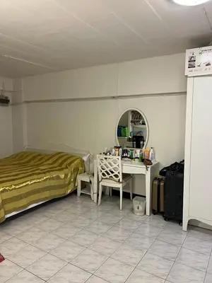 a bedroom with a bed and a desk and a mirror at Mahasap Ramindhra next to MRT Station in Bang Khen
