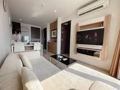 a living room with a couch and a flat screen tv at Luxurious Downtown River View chao phraya river in Bangkok