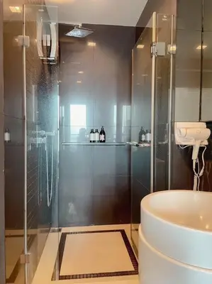 a bathroom with a shower with a toilet and a sink at Luxurious Downtown River View chao phraya river in Bangkok