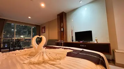 a swan is sitting on top of a bed at Sam Homestay in Bangkok