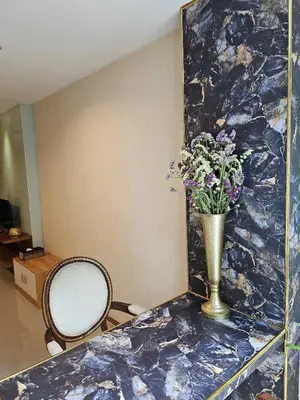 a vase of flowers sitting on a counter in a room at Sam Homestay in Bangkok