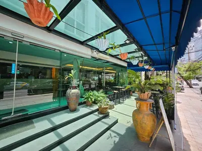 a store front with a bunch of potted plants at Sam Homestay in Bangkok