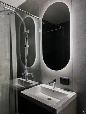 a bathroom with a sink and a mirror at Brown Brick Thonglor - Blue Blueberry Room in Khlong Toei