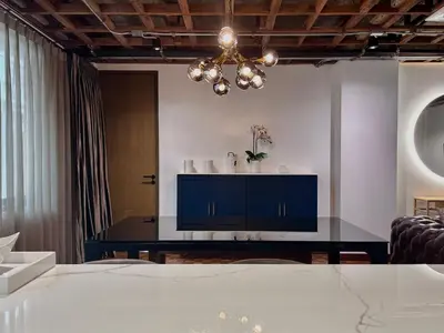 a dining room with a blue cabinet and a chandelier at Brown Brick Thonglor - Blue Blueberry Room in Khlong Toei