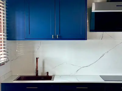 a kitchen with blue cabinets and a sink at Brown Brick Thonglor - Blue Blueberry Room in Khlong Toei