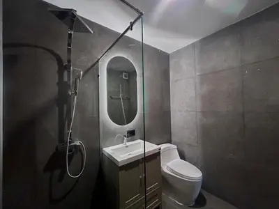 a bathroom with a toilet and a sink and a mirror at Brown Brick Thonglor - Blue Blueberry Room in Khlong Toei