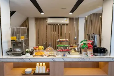 a buffet of food on a counter in a room at Adamaz House in Bangkok