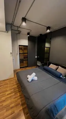 a bedroom with a large bed with two towels on it at Cozy 2BR Duplex-Apartment in Thong Lor in Bangkok