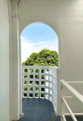 an archway in a white building with a window at Megun 10 in Ban Bang Phlat