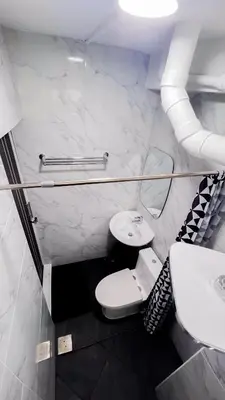 a bathroom with a toilet and a sink at uouRangnamHouse in Bangkok