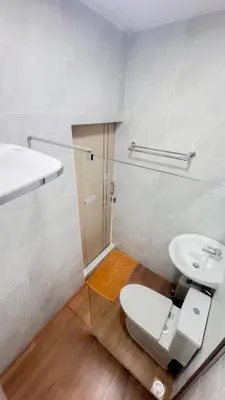 a bathroom with a toilet and a sink at uouRangnamHouse in Bangkok