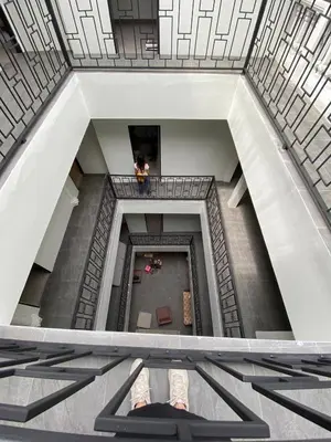 a person standing on a balcony in a building at Hidden Dragon Yaowarat MRT วัดมังกร in Samphanthawong