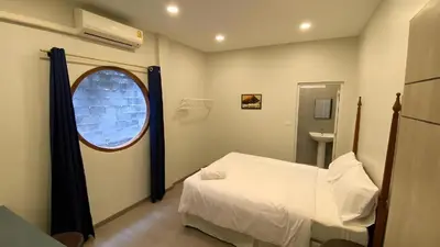 a small room with a bed and a window at XX HD China Town MRT Dragon Temple in Samphanthawong
