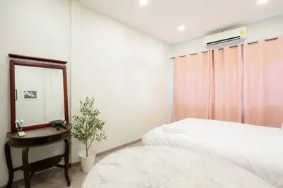 a bedroom with a mirror and a bed and a table at XX HD China Town MRT Dragon Temple in Samphanthawong