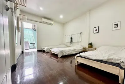 a room with two beds and a window at Homemii 59 in Ban Chuat Plai Mai