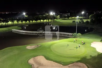 a group of people on a golf course at night at Homemii 59 in Ban Chuat Plai Mai