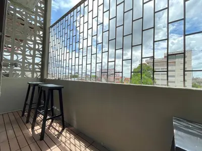 a bar with two stools in front of a large window at Vélin Khaosan - 5th Floor apartment with 2Bedrooms in Bangkok