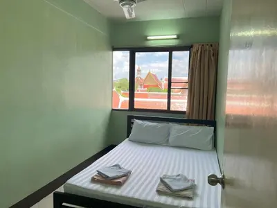 a bedroom with a bed with two towels on it at Bella Bella House in Bangkok