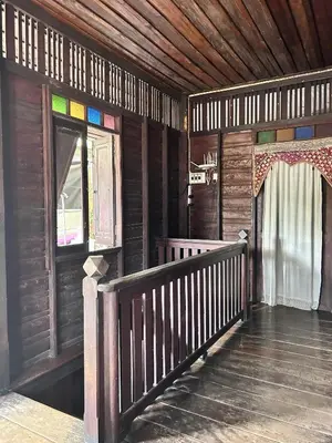a wooden cabin with a staircase and a window at Chest's Place in Bangkok