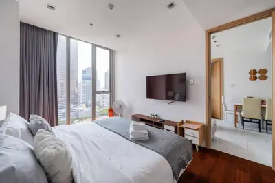 a bedroom with a large bed and a large window at 2 BR Suite at BTS NANA Sukhumvit 11 Floor 15 Pool not permitted in Bangkok