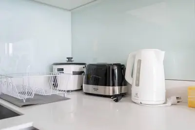 a kitchen with three appliances on a counter at 2 BR Suite at BTS NANA Sukhumvit 11 Floor 15 Pool not permitted in Bangkok