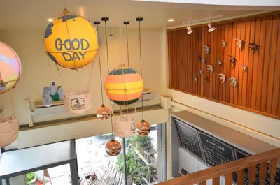a restaurant with a good day hanging from the ceiling at Good Day Hostel in Bangkok