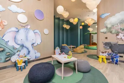 a childs play area with an elephant and animals on the wall at Cassia Rama 9 Bangkok, part of Banyan Group in Bangkok