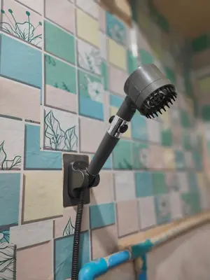 a blow dryer on the wall of a bathroom at 204 Olan Place Spacious Studio with Wi-fi near BTS Skytrain in Bangkok